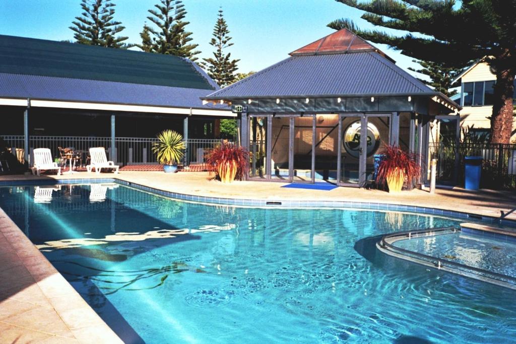 a hotel room with a pool and a balcony at BIG4 Middleton Beach Holiday Park in Albany