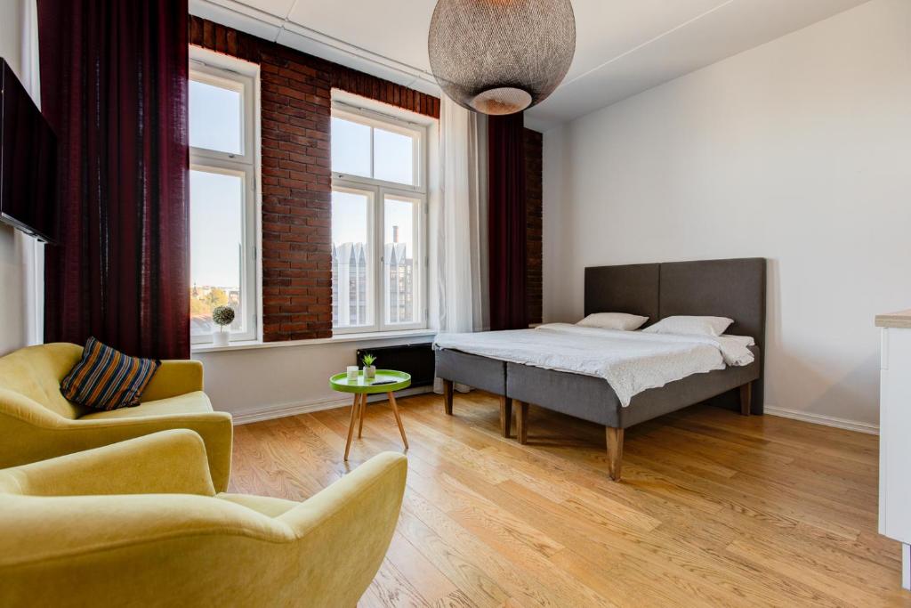a bedroom with a bed and a couch at Stylish Studio in Perfect Location, 24h Reception in Tallinn