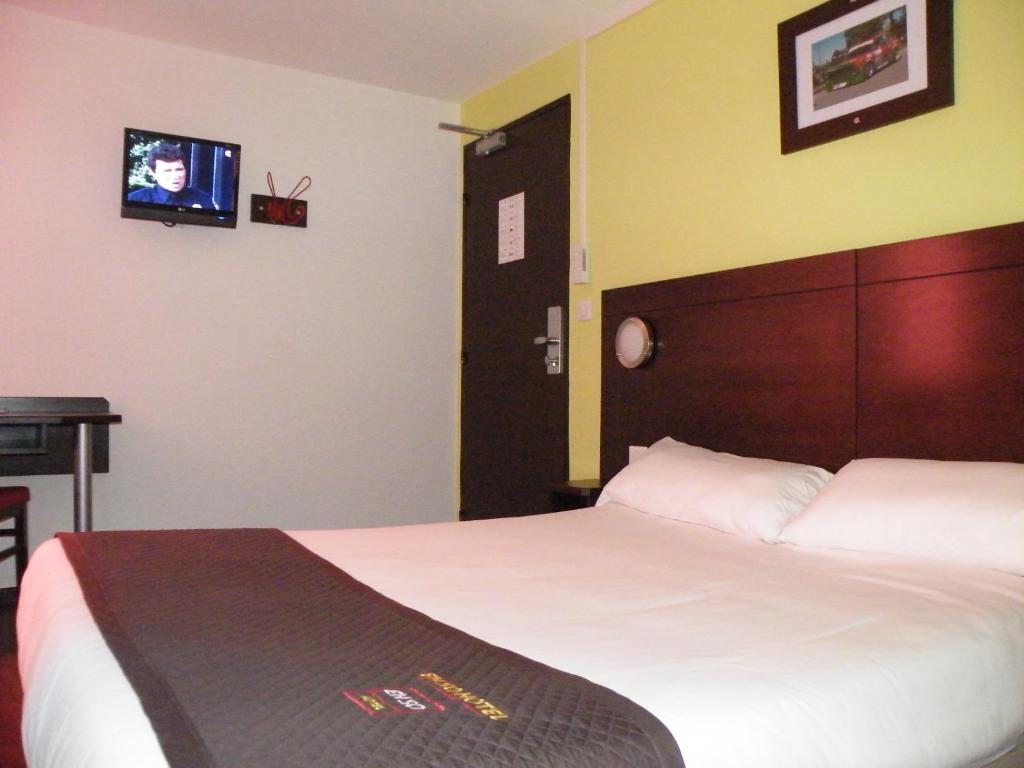 Postel nebo postele na pokoji v ubytování Enzo Hotel Mulhouse Sud Morschwiller le Bas