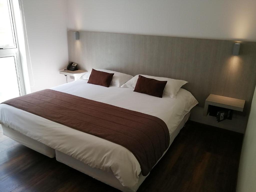 Postel nebo postele na pokoji v ubytování Hotel Elisa Cole