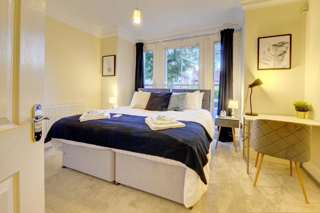 a bedroom with a large bed and a window at Leamington Spa Warwick Place Apartments in Leamington Spa