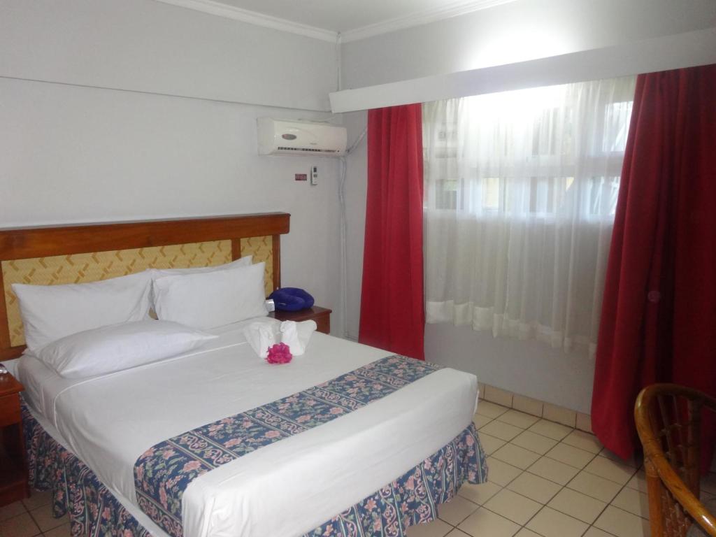 Postel nebo postele na pokoji v ubytování Suva Motor Inn