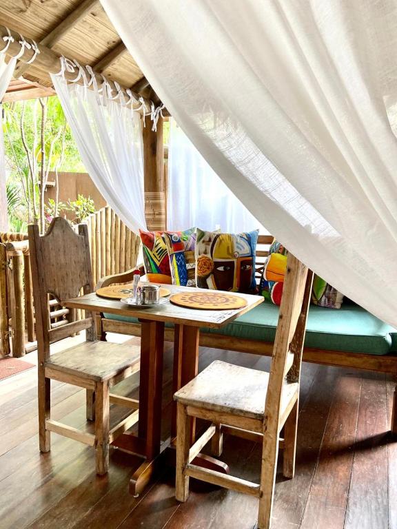 a table and chairs with a table and a couch at Pousada João Sol in Praia do Forte