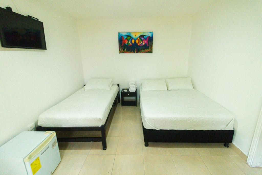 Postel nebo postele na pokoji v ubytování Hotel Balcones de Bocagrande