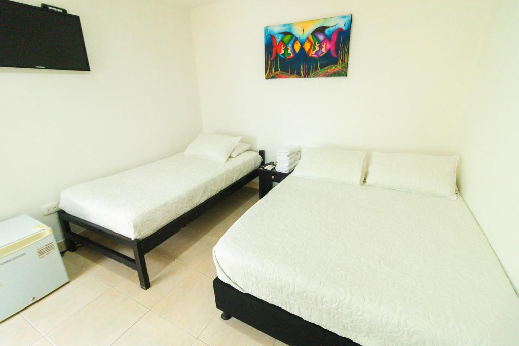 Postel nebo postele na pokoji v ubytování Hotel Balcones de Bocagrande