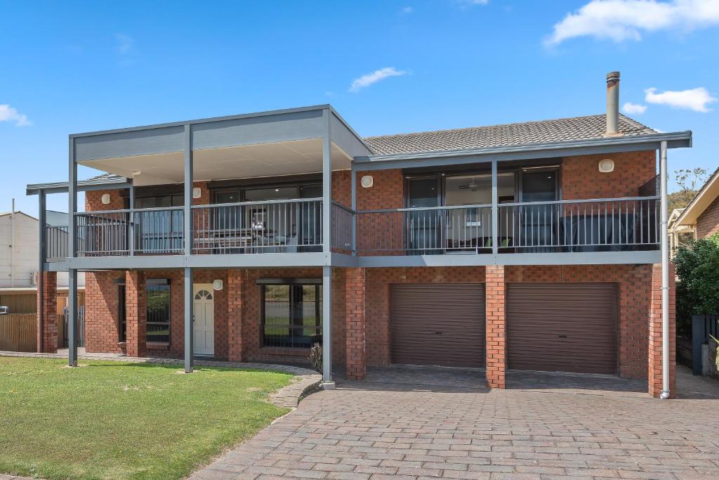 a large brick house with two garage doors at Beach House at Moana - C21 SouthCoast Holidays in Moana