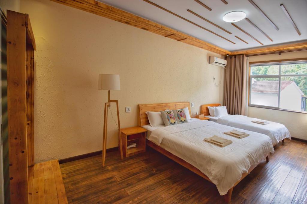 Postel nebo postele na pokoji v ubytování Moganshan Bamboo View Guesthouse
