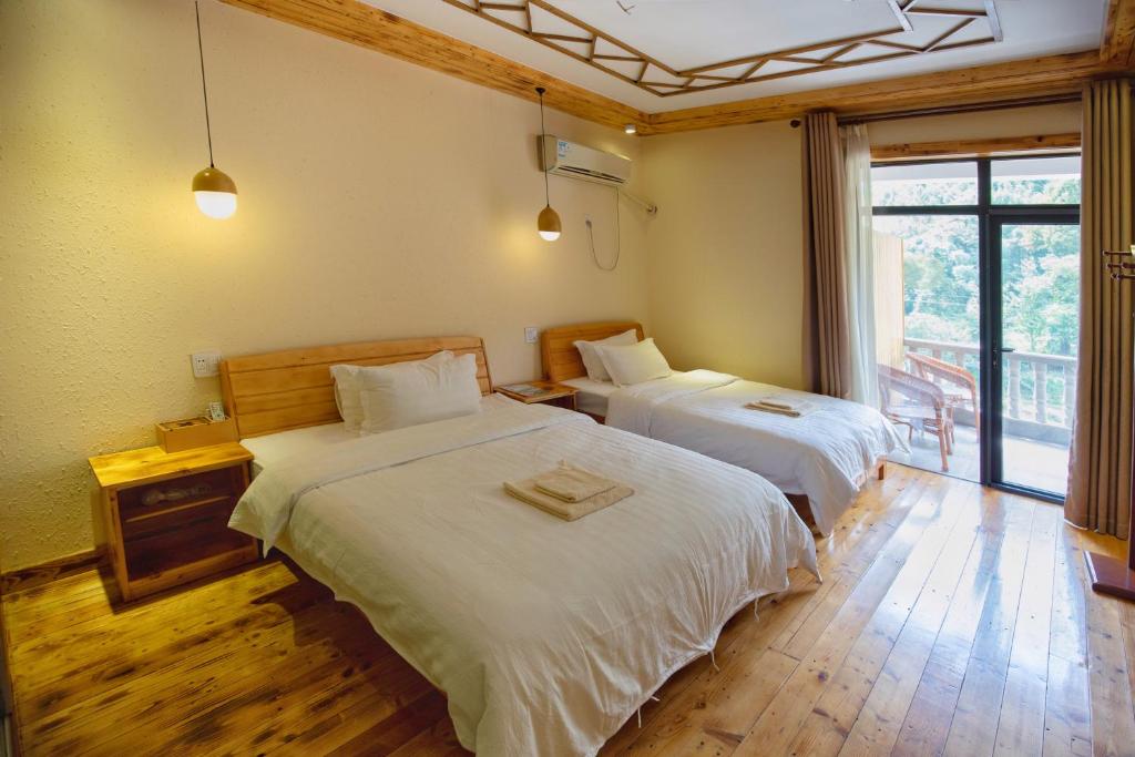 Postel nebo postele na pokoji v ubytování Moganshan Bamboo View Guesthouse