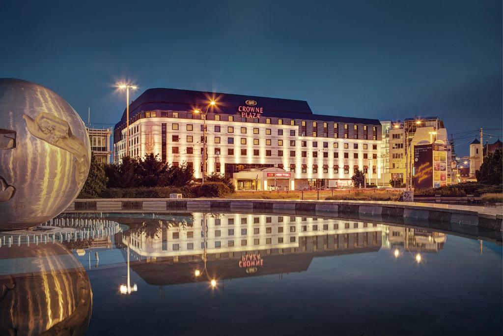 a large swimming pool in front of a large building at Crowne Plaza Bratislava, an IHG Hotel in Bratislava