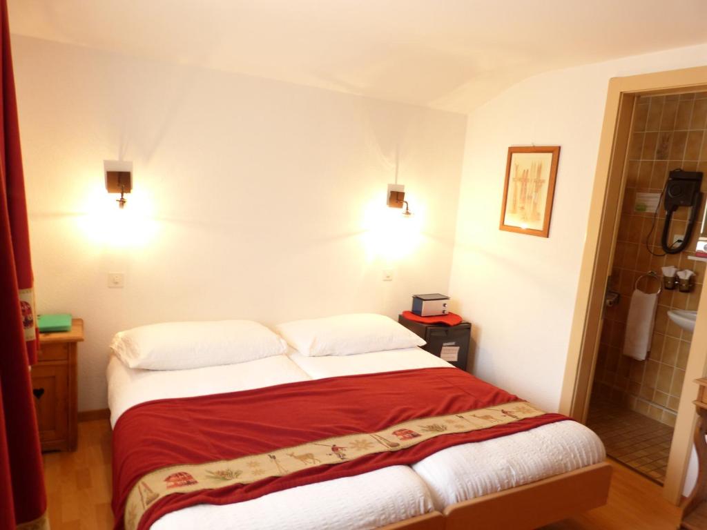 Postel nebo postele na pokoji v ubytování Hotel Ermitage Verbier