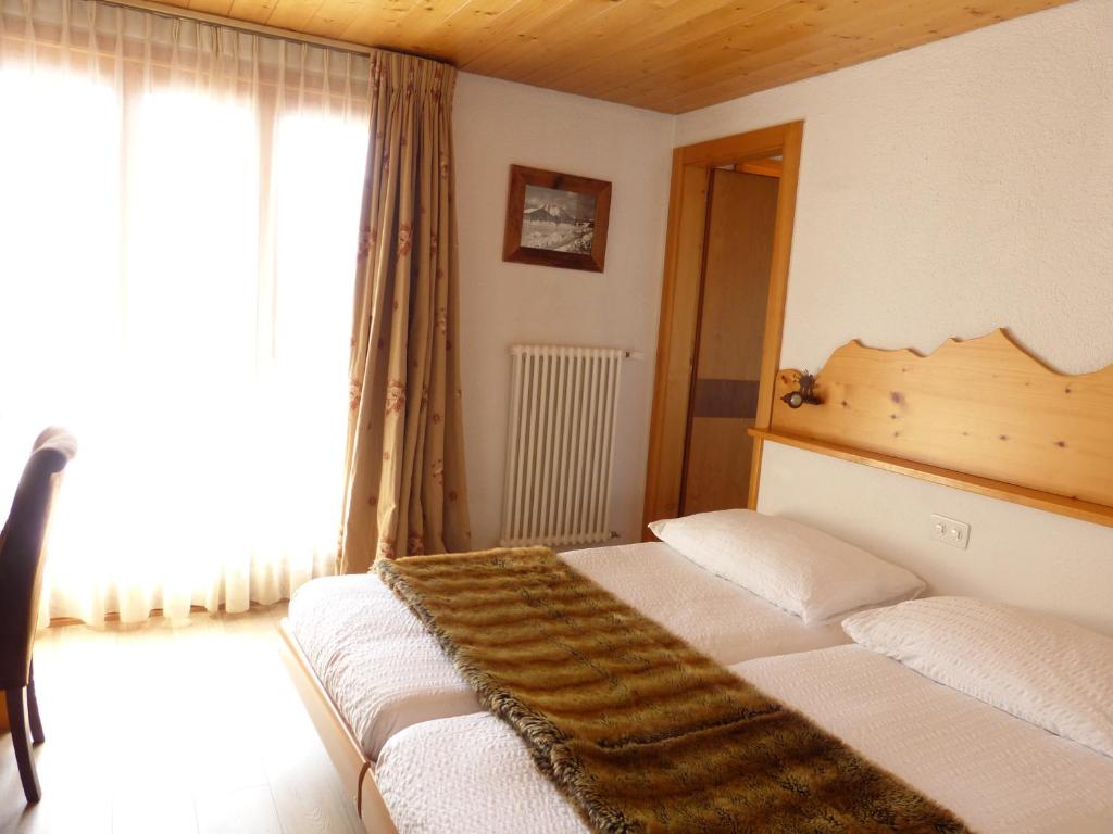 Postel nebo postele na pokoji v ubytování Hotel Ermitage Verbier