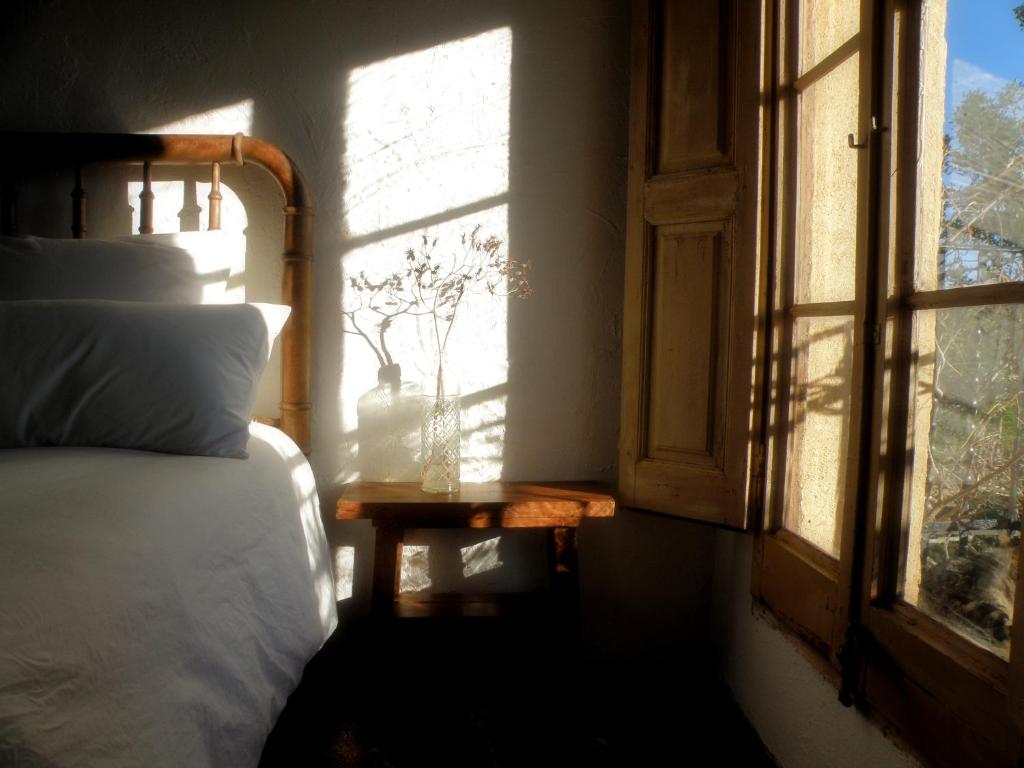 een slaapkamer met een bed en een open raam bij Mas de Mingall in Les tres Cales