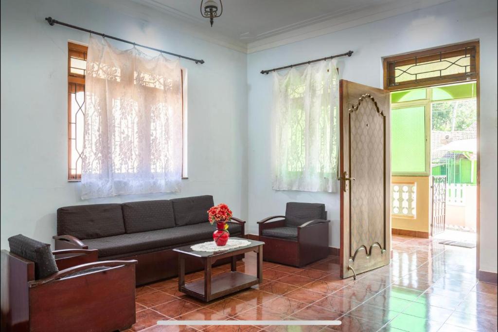 a living room with a couch and a table at Cozy 2BHK villa in South Goa near the Beach!! in Utorda