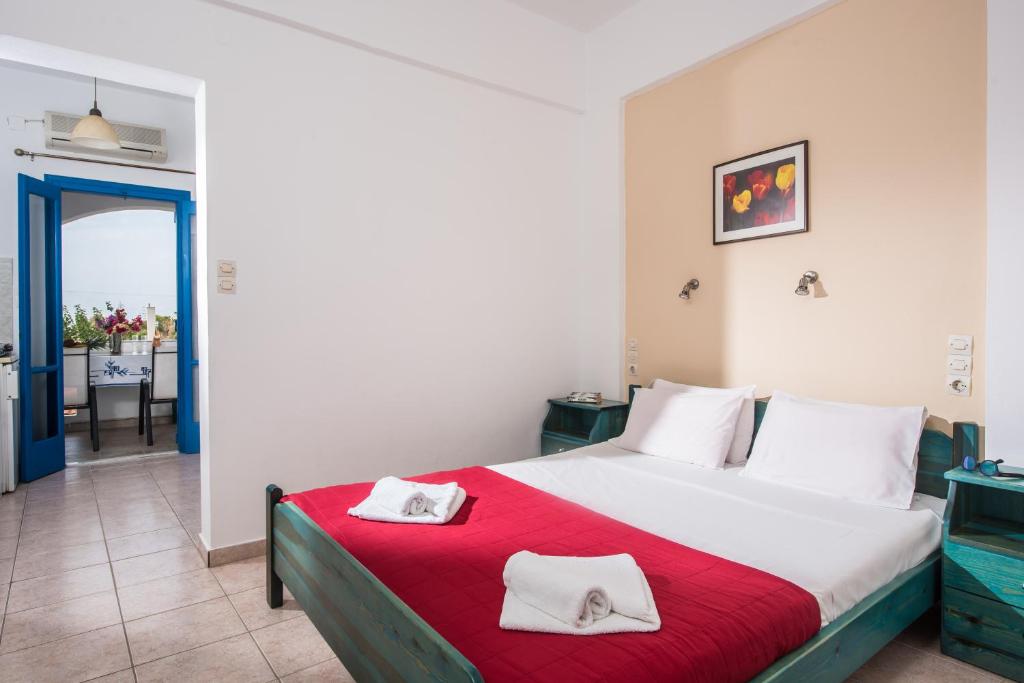 a bedroom with a bed with two towels on it at Hotel Aglaia in Kalamaki