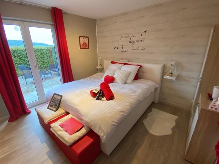 a bedroom with a bed with a teddy bear on it at La Milardière in Theux