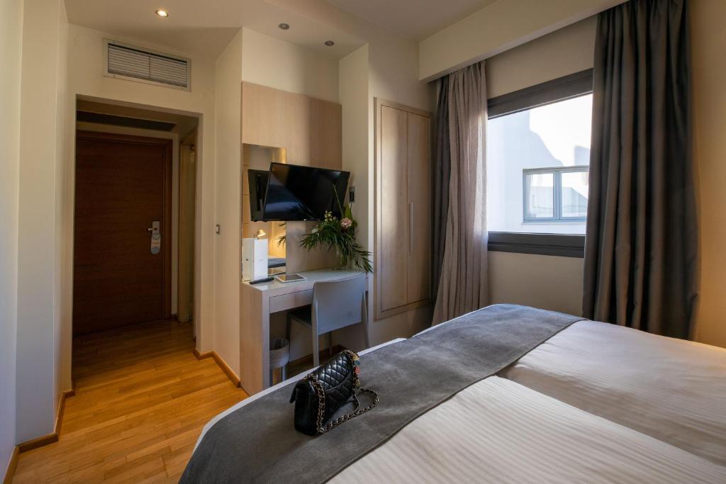 Postel nebo postele na pokoji v ubytování Domotel Olympia