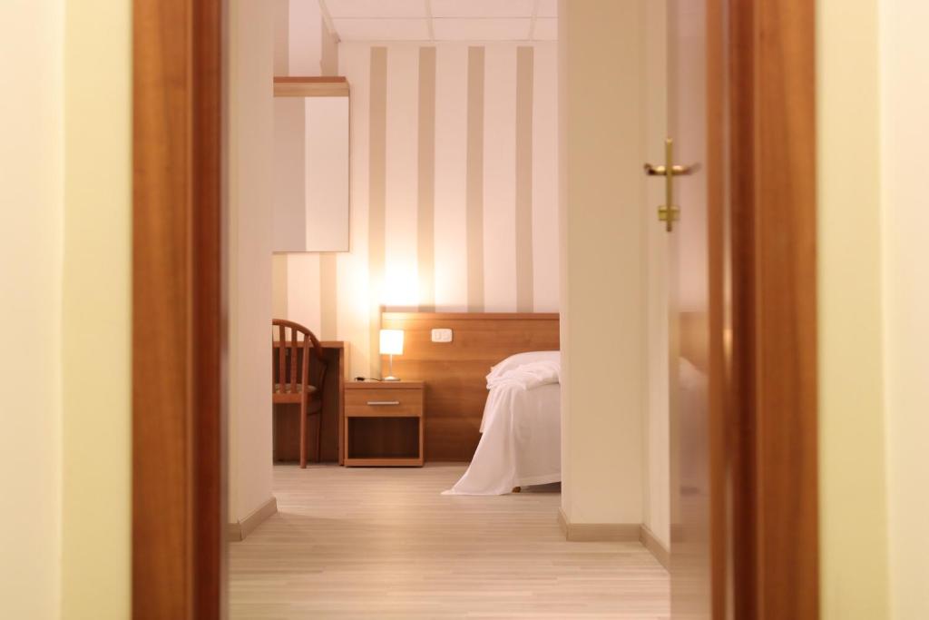 Voodi või voodid majutusasutuse Hotel Castel Miramonti toas