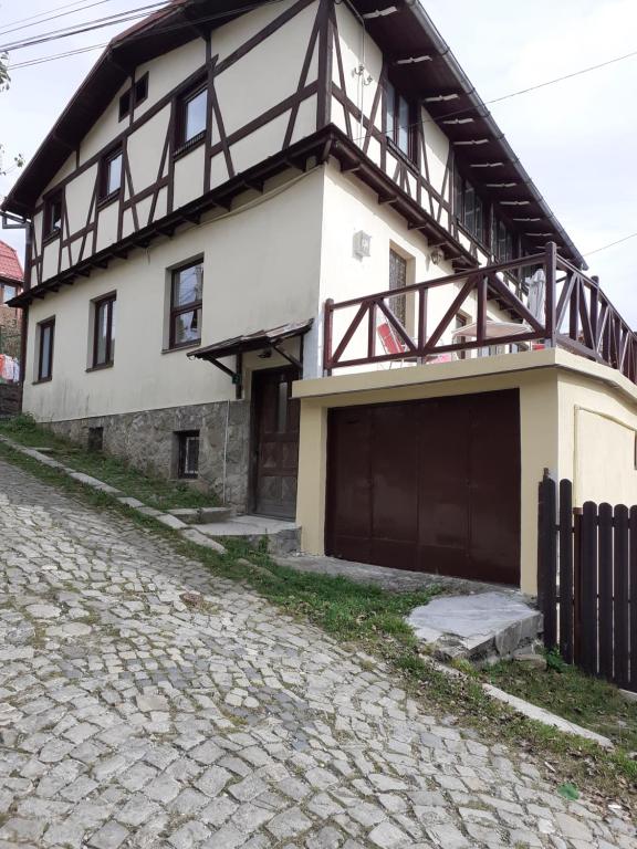 a house with a balcony on top of it at Casa Insorita in Sinaia