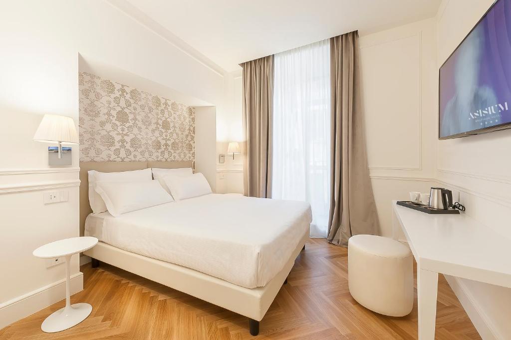 Łóżko lub łóżka w pokoju w obiekcie Asisium Boutique Hotel