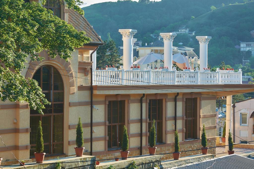 a large building with a balcony with avisorangering at Boutique-Hotel Simfonia in Kislovodsk