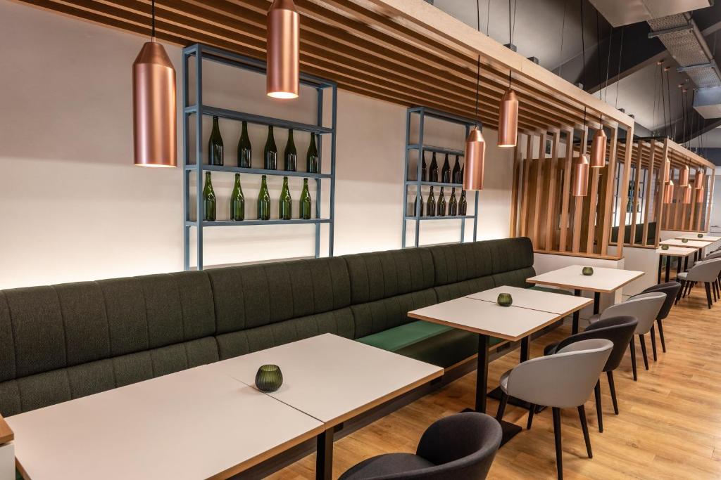 a restaurant with tables and chairs and wine bottles at Holiday Inn Dover by IHG in Dover