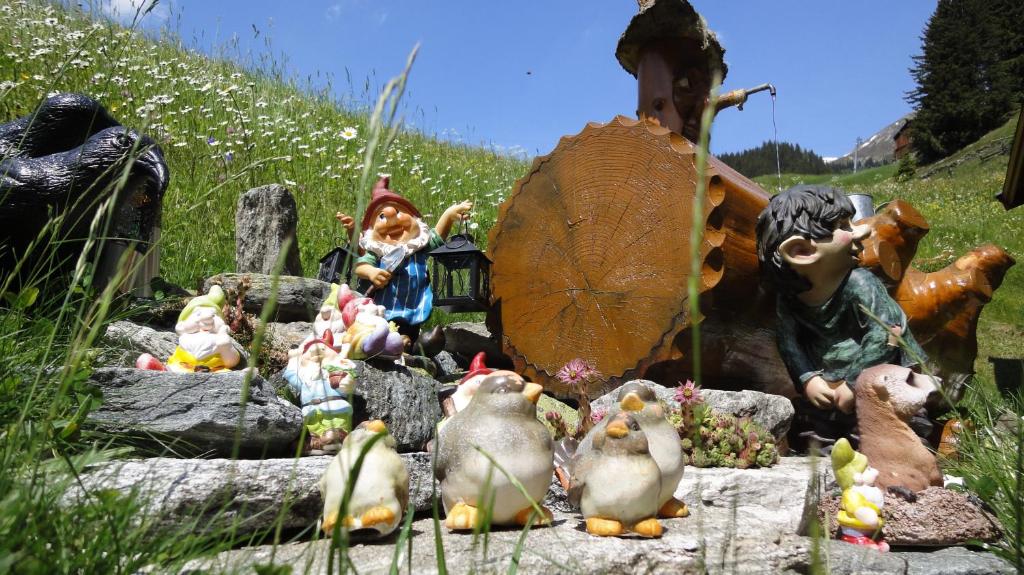 a group of figurines sitting on rocks in a field at Chasa Monthani in Ischgl