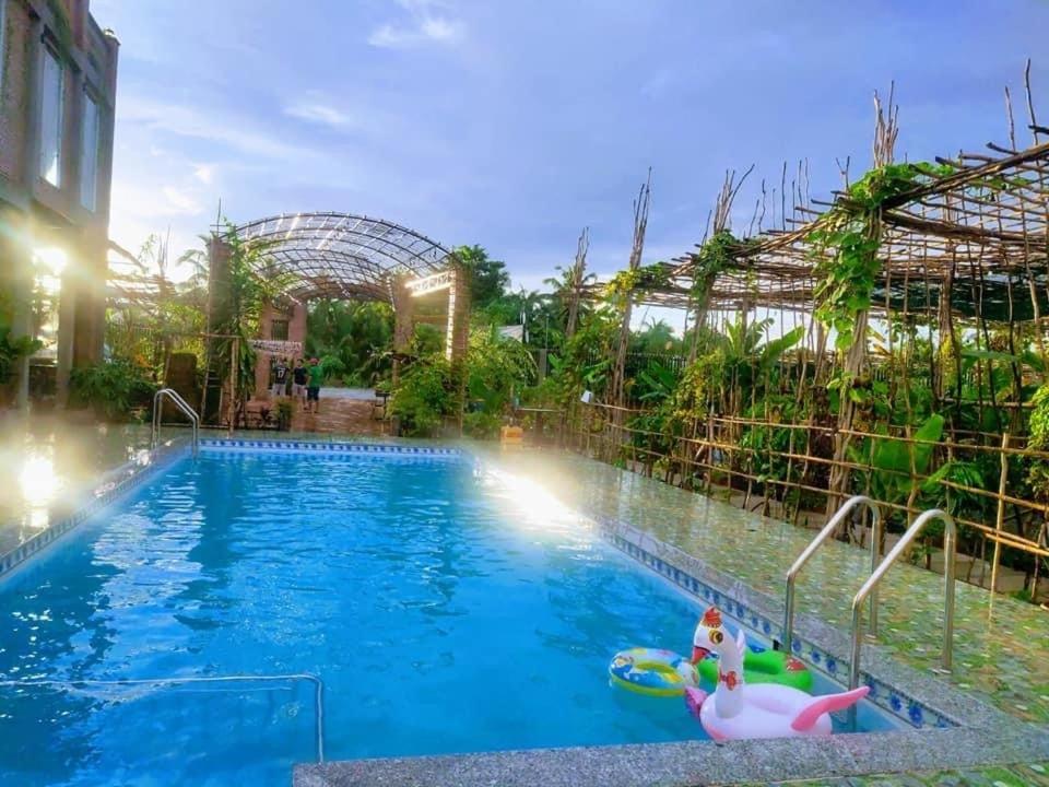 a swimming pool at a resort with a water park at Bầu Bí Mini Farmstay Mekong - Tiền Giang in Mỹ Tho