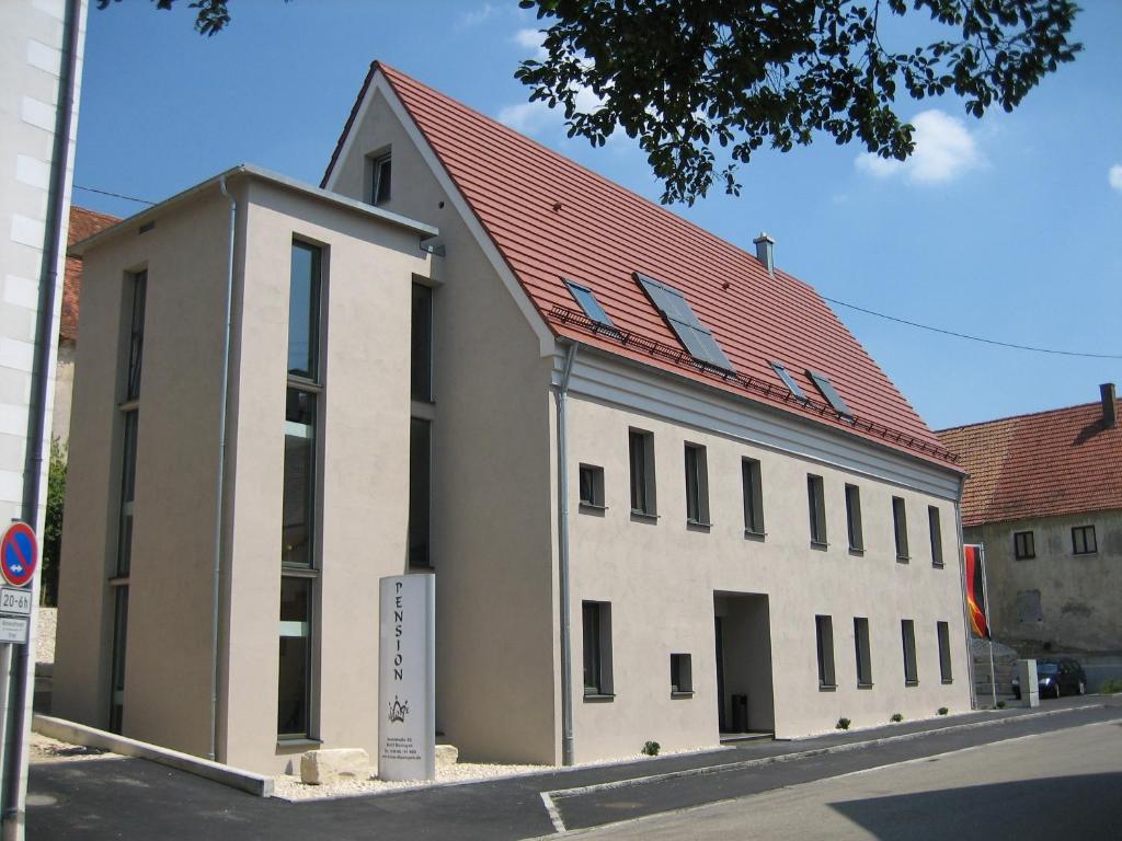 a large white building with a red roof at Gasthof Krone in Bissingen