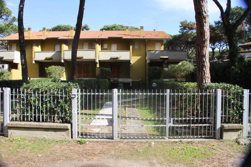 a white fence in front of a house at Le Arselle in Principina a Mare