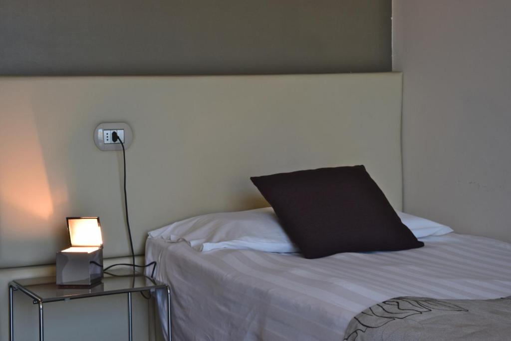 Postel nebo postele na pokoji v ubytování Piccolo Hotel
