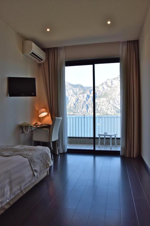 Postel nebo postele na pokoji v ubytování Piccolo Hotel