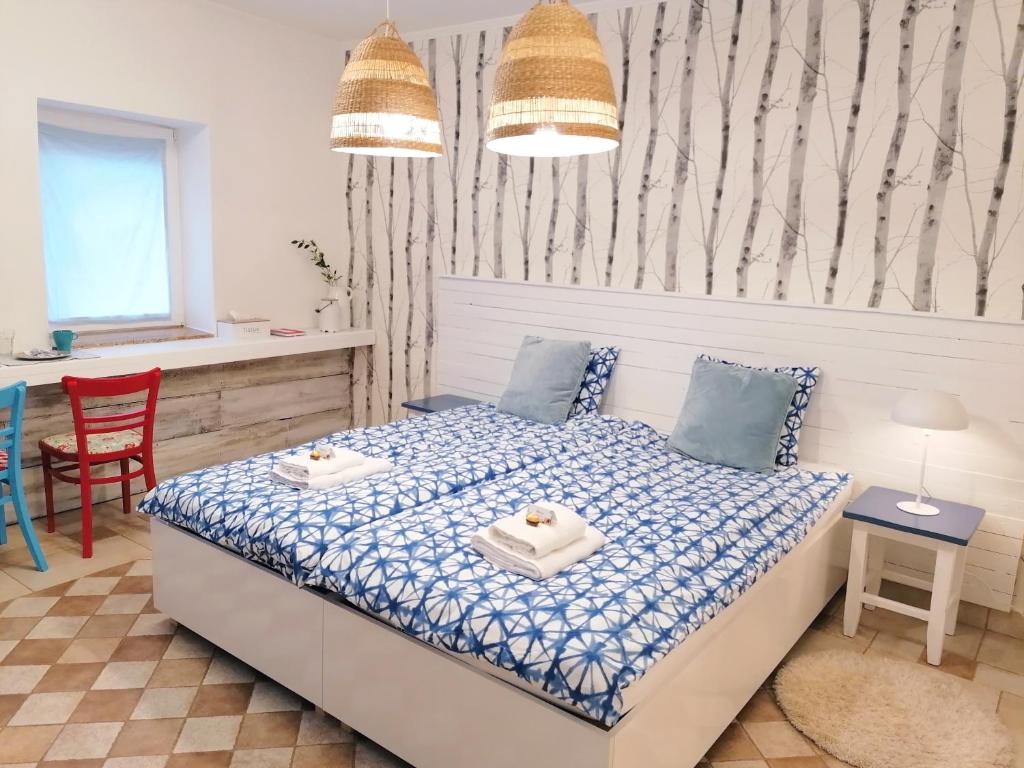 a bedroom with a bed and a table and chairs at Jászberény Boutique Room in Jászberény