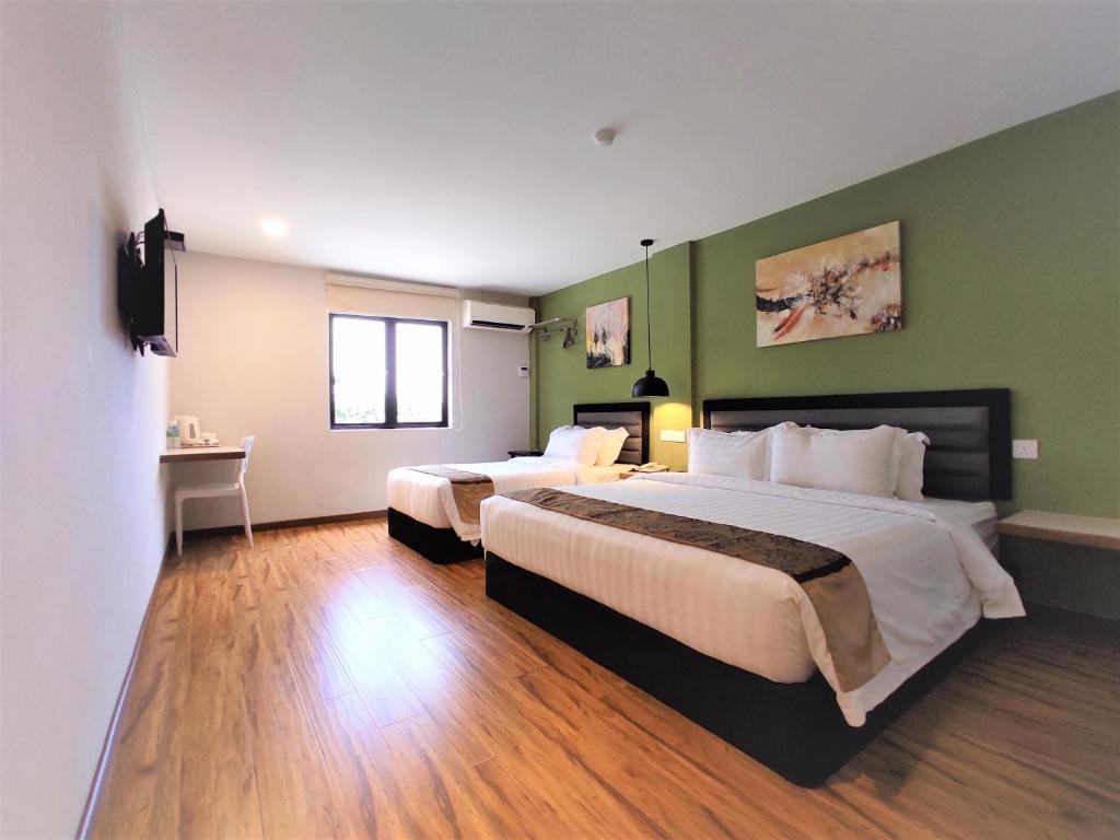 Postel nebo postele na pokoji v ubytování Apple Suites Hotel