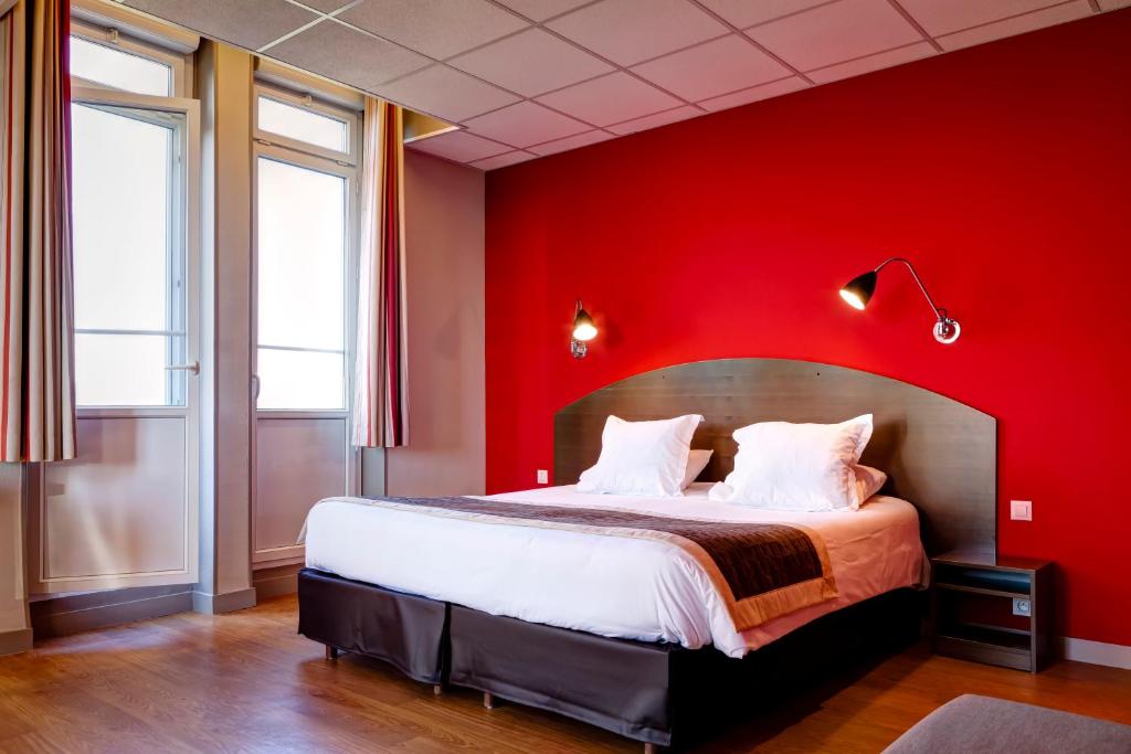 a bedroom with a red wall and a bed at Domaine Lyon Saint Joseph in Sainte-Foy-lès-Lyon