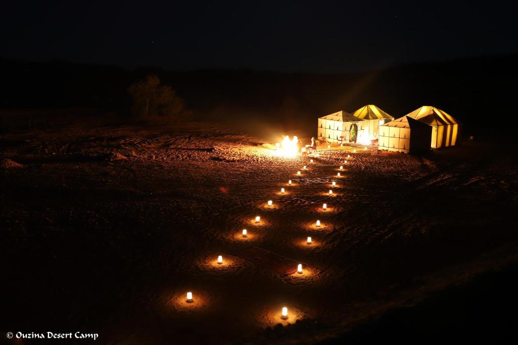 a group of lit candles in a field at night at Ouzina Desert Camp in Ouzina
