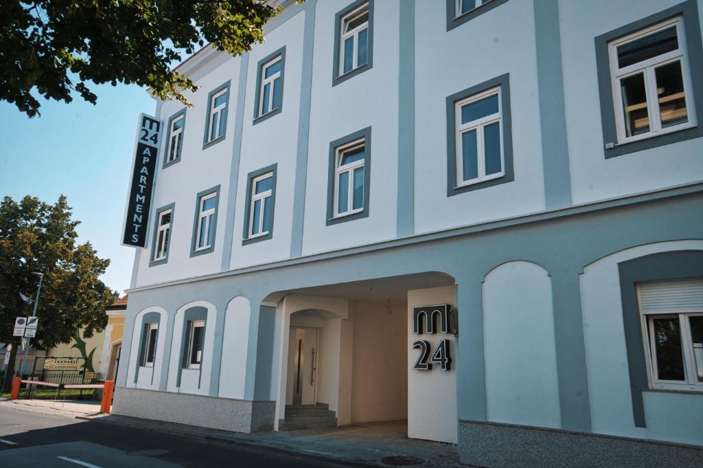 a blue building with the number on it at M-24 Apartments in Mattersburg