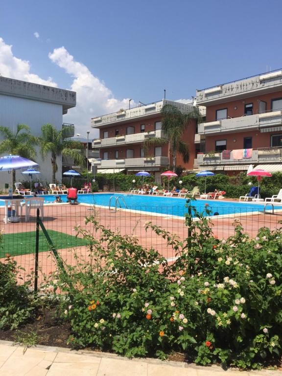 a swimming pool in front of a hotel at Taormina Mare Piscina Fondachello in Fondachello