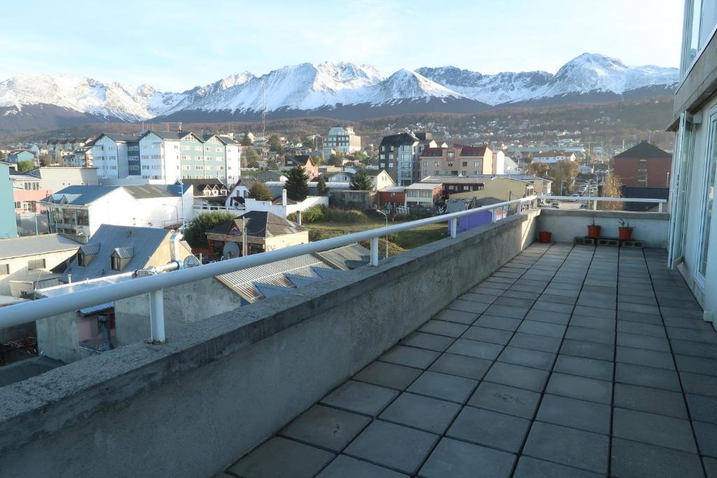 a balcony with a view of a city and mountains at Lo de Moli 5A in Ushuaia