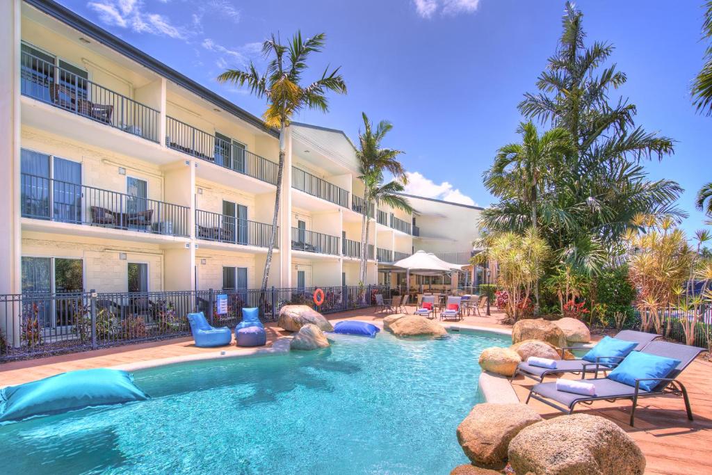 a swimming pool in front of a hotel at Cairns Queenslander Hotel & Apartments in Cairns