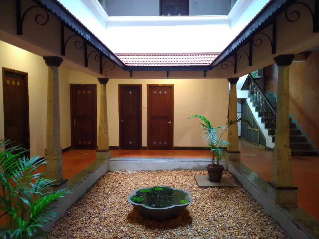 een kamer met een fontein in het midden van een gebouw bij Harmony in Auroville