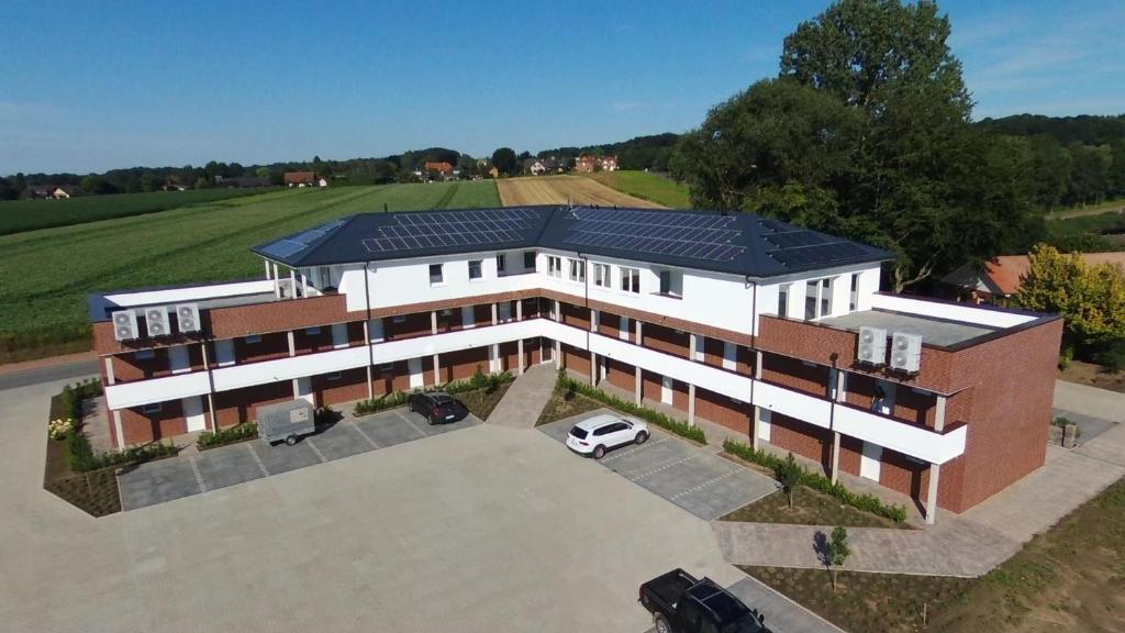 an aerial view of a building with solar panels on it at Waldhotel zum Bergsee Damme in Damme