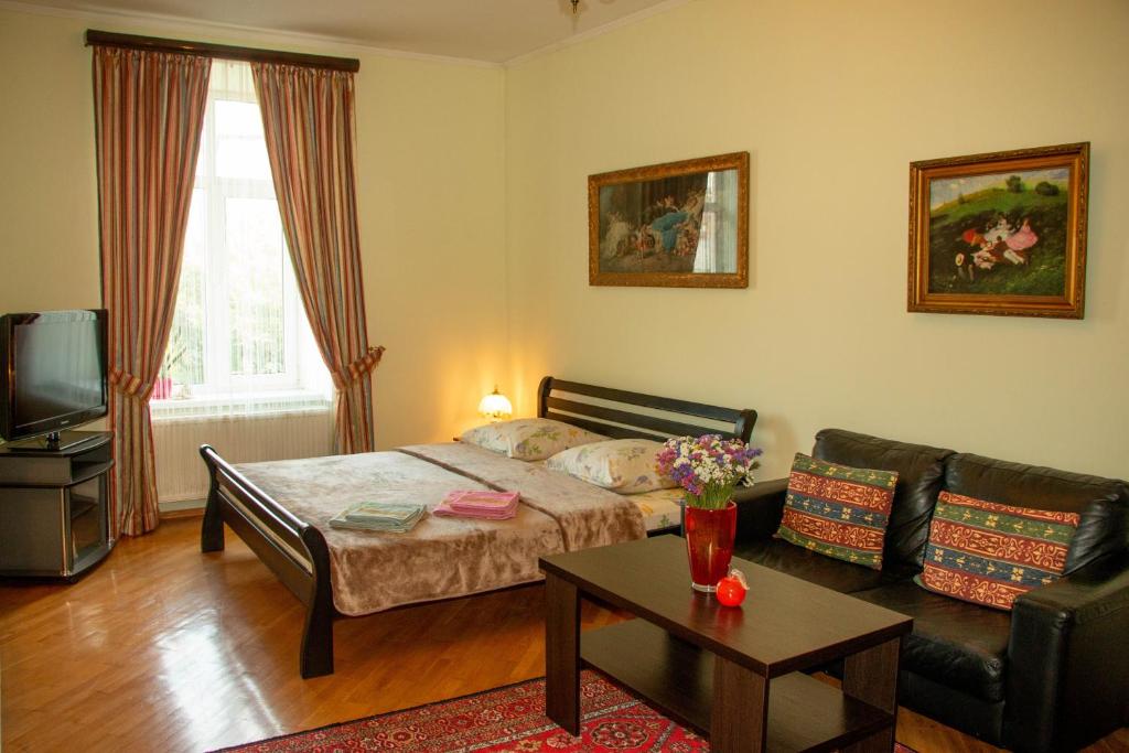 salon z łóżkiem i kanapą w obiekcie The heart of Lviv w Lwowie
