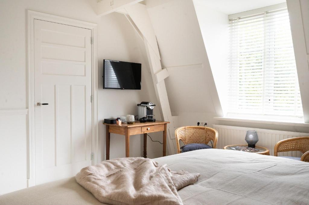Postel nebo postele na pokoji v ubytování Boutique Hotel - de Stadsherberg Alphen