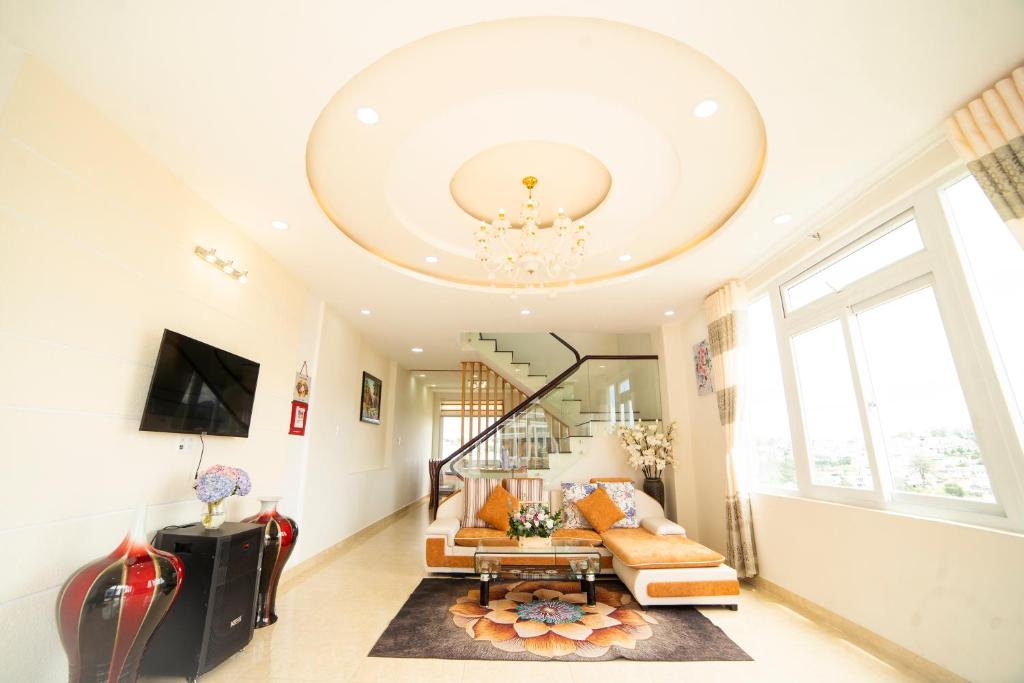 a living room with a couch and a chandelier at Asagari Dalat in Da Lat