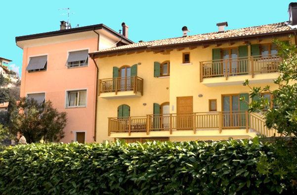 a large apartment building with balconies and a hedge at Windshouse in Nago-Torbole