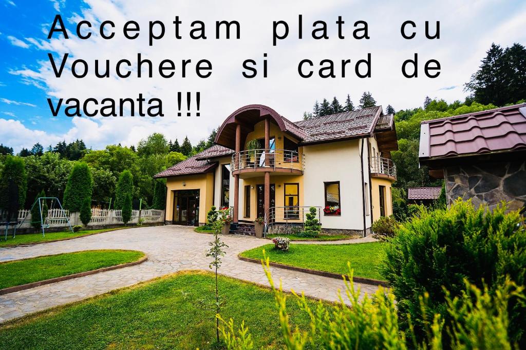 a house with the words acropolitán plaza cu volunteer st card bc v at Perla Nordului in Moisei