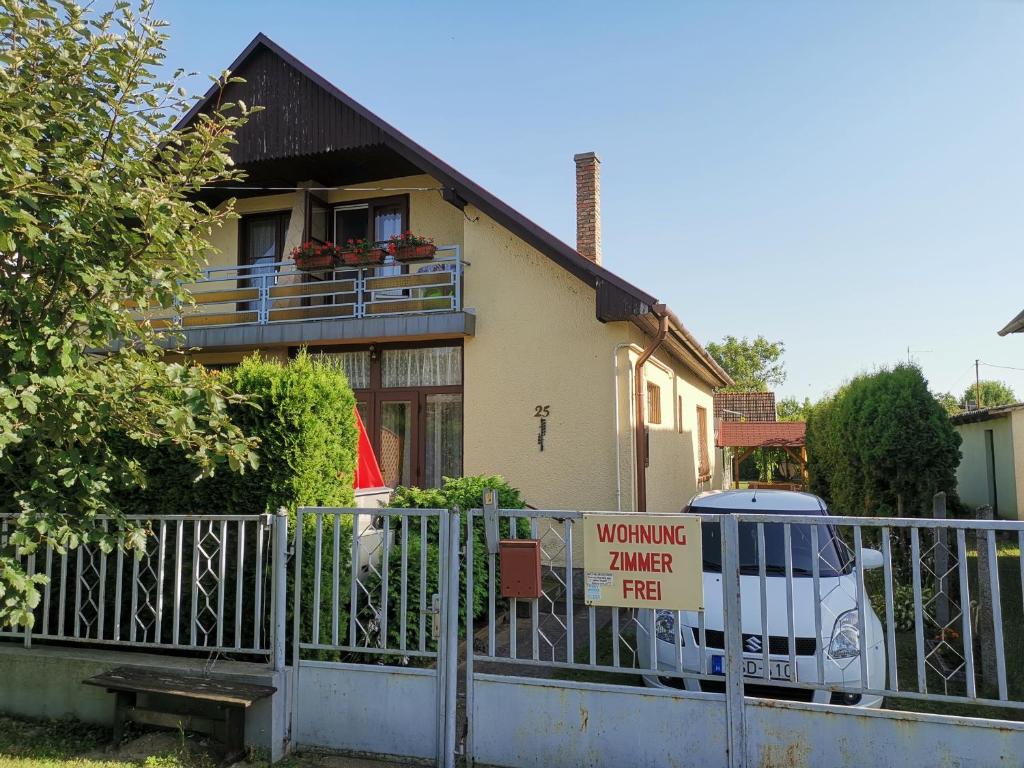a house with a warning sign in front of it at Anna Ház in Balatonkeresztúr