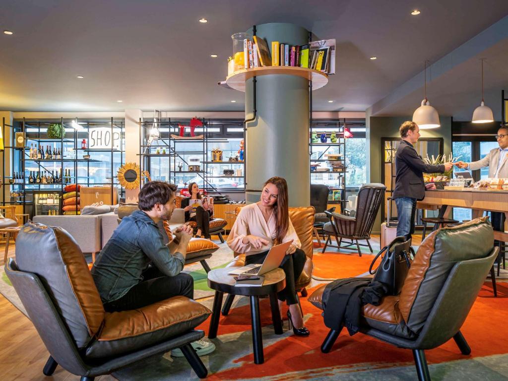 a group of people sitting in chairs in a lobby at Aparthotel Adagio Paris Bercy Village in Paris