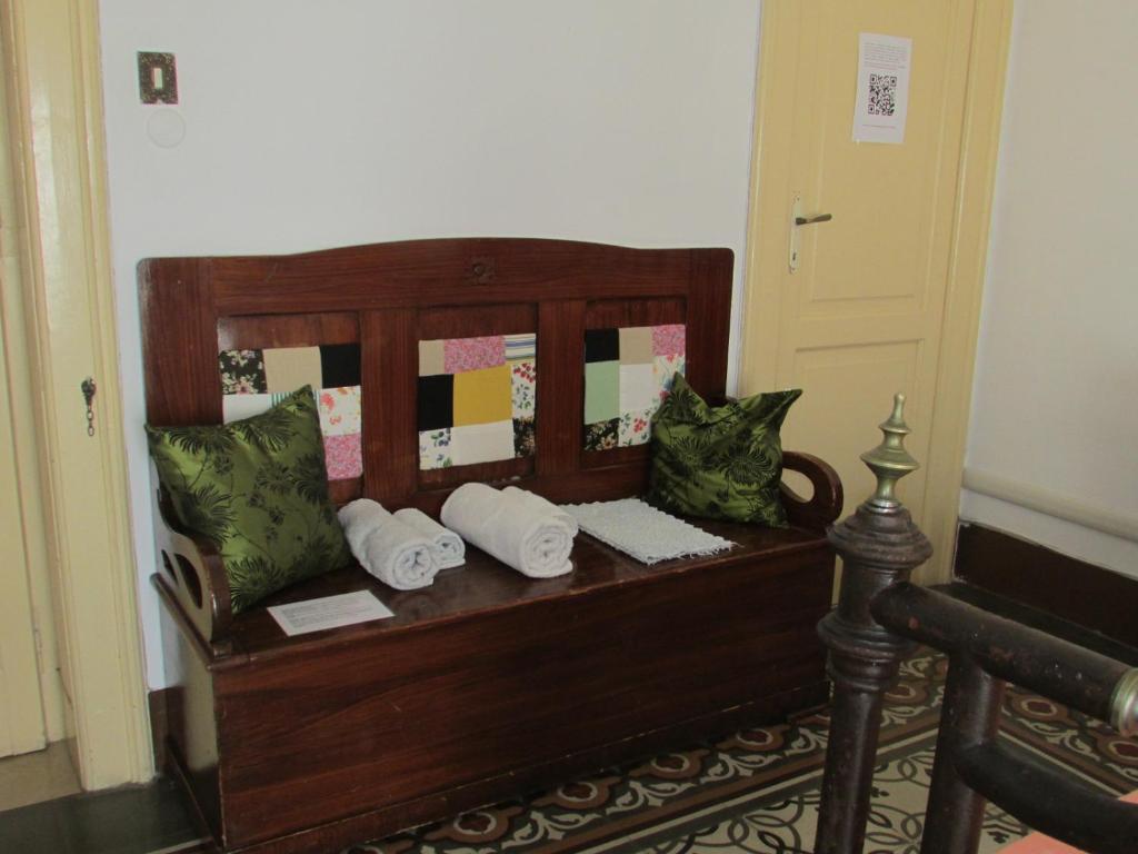 a wooden bench with pillows on it in a room at Guesthouse City Center in Bari