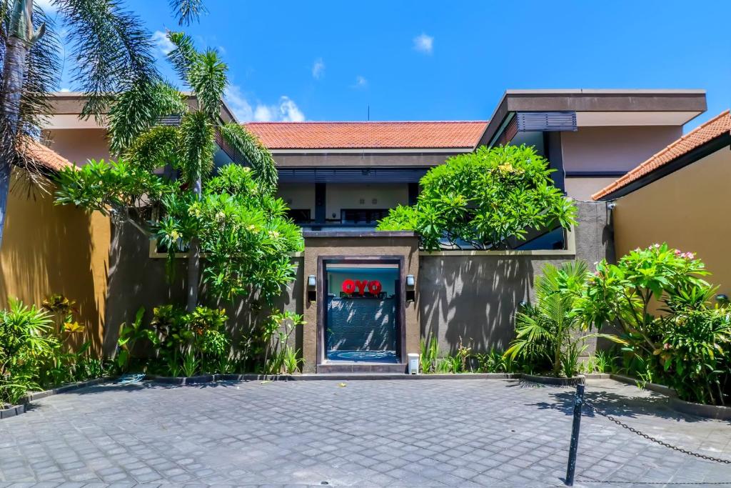 a house with a driveway in front of it at OYO 2143 Leluhur Bali Apartment in Seminyak